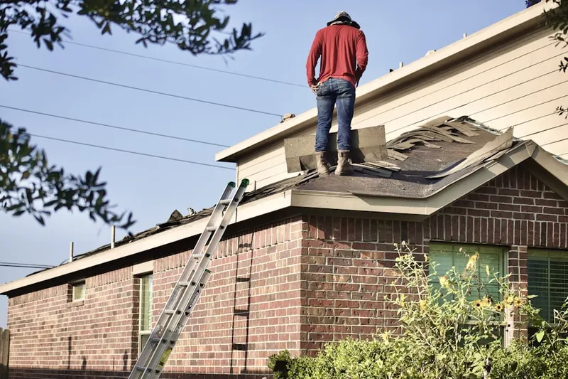 Professional roofer working on a residential roof in Highland Oaks